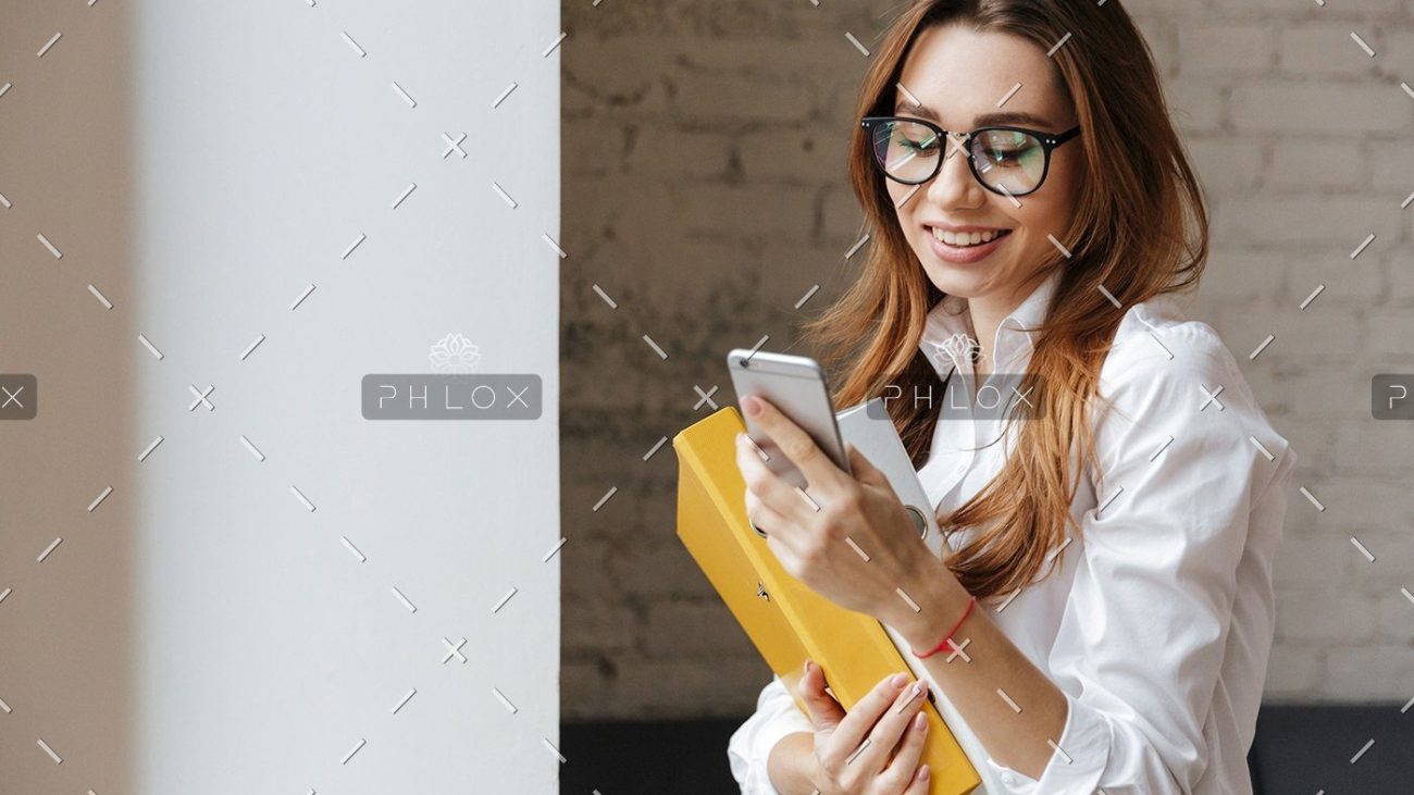 demo-attachment-175-happy-business-woman-indoors-using-mobile-phone-P9WS3SD